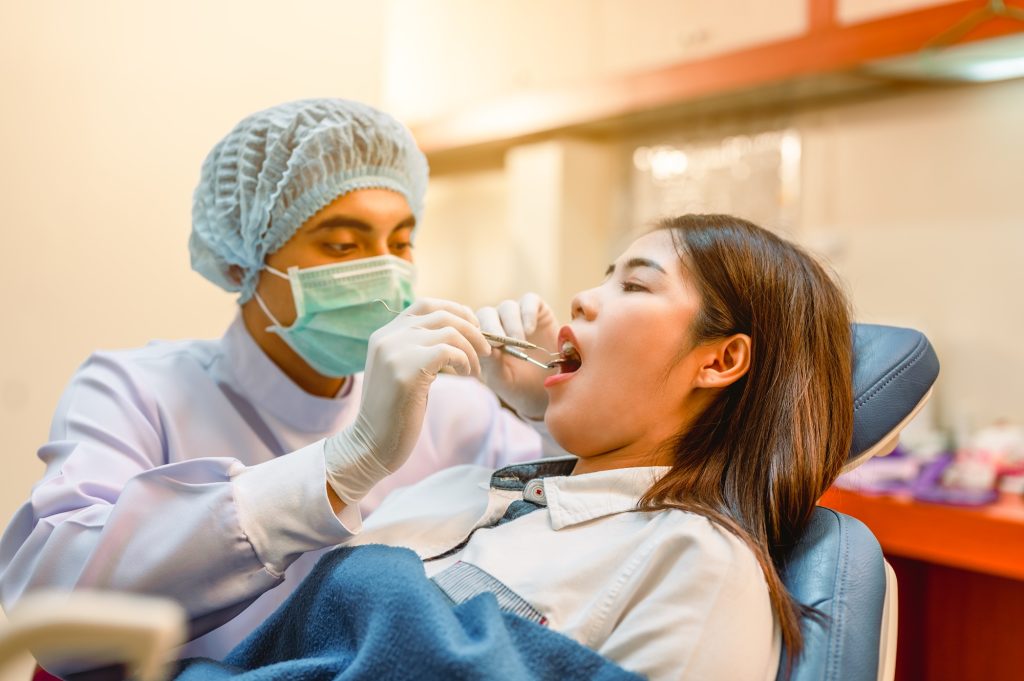 Emergency dentist treating a patient in Leawood, KS